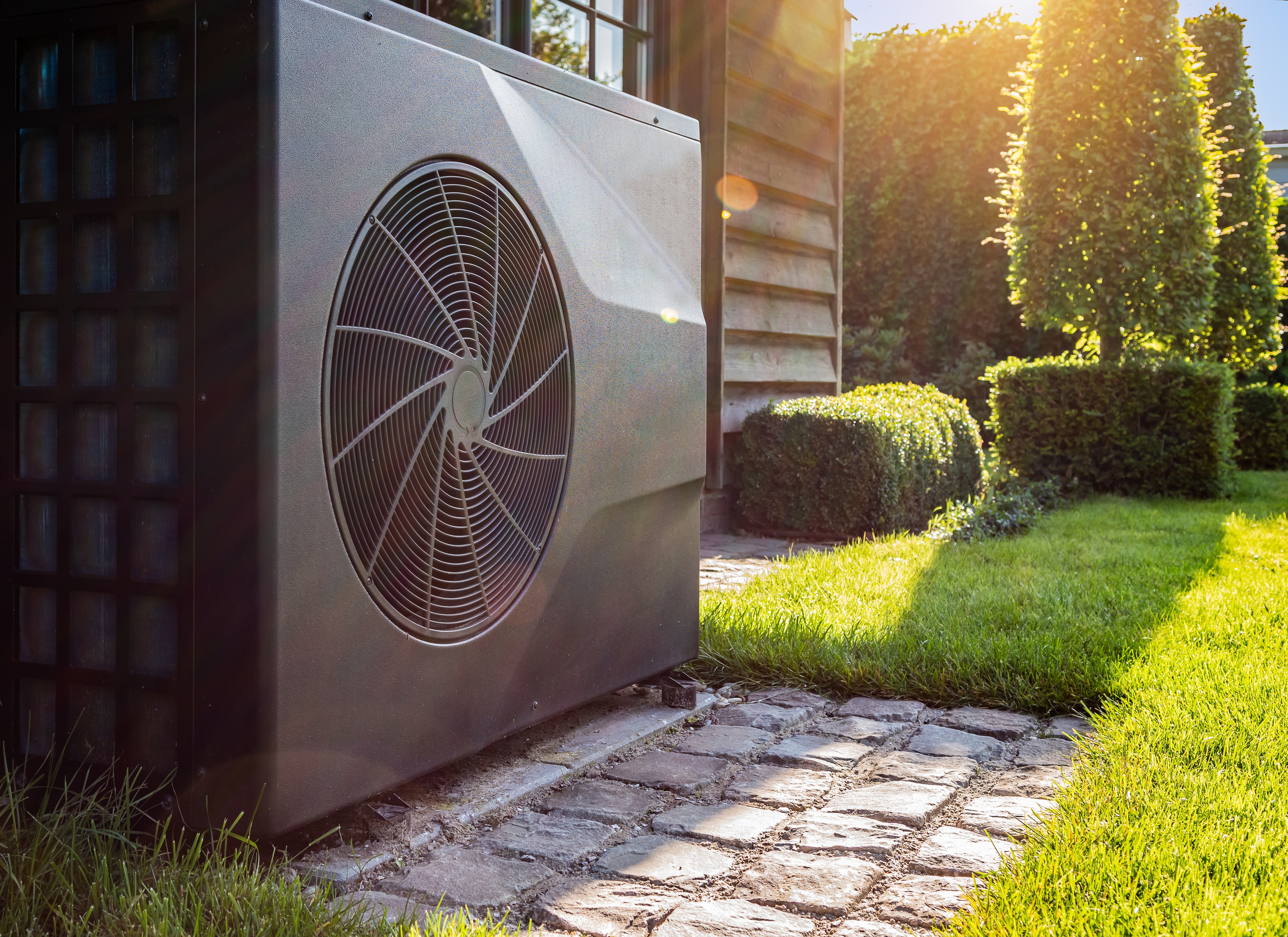 Heat pump outside with sun and grass.jpg