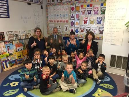 Deputy Superintendent Salam Noor with a classroom of first graders