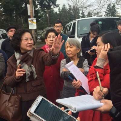 A group of community members is gathered outside and sharing with ODOT workers.