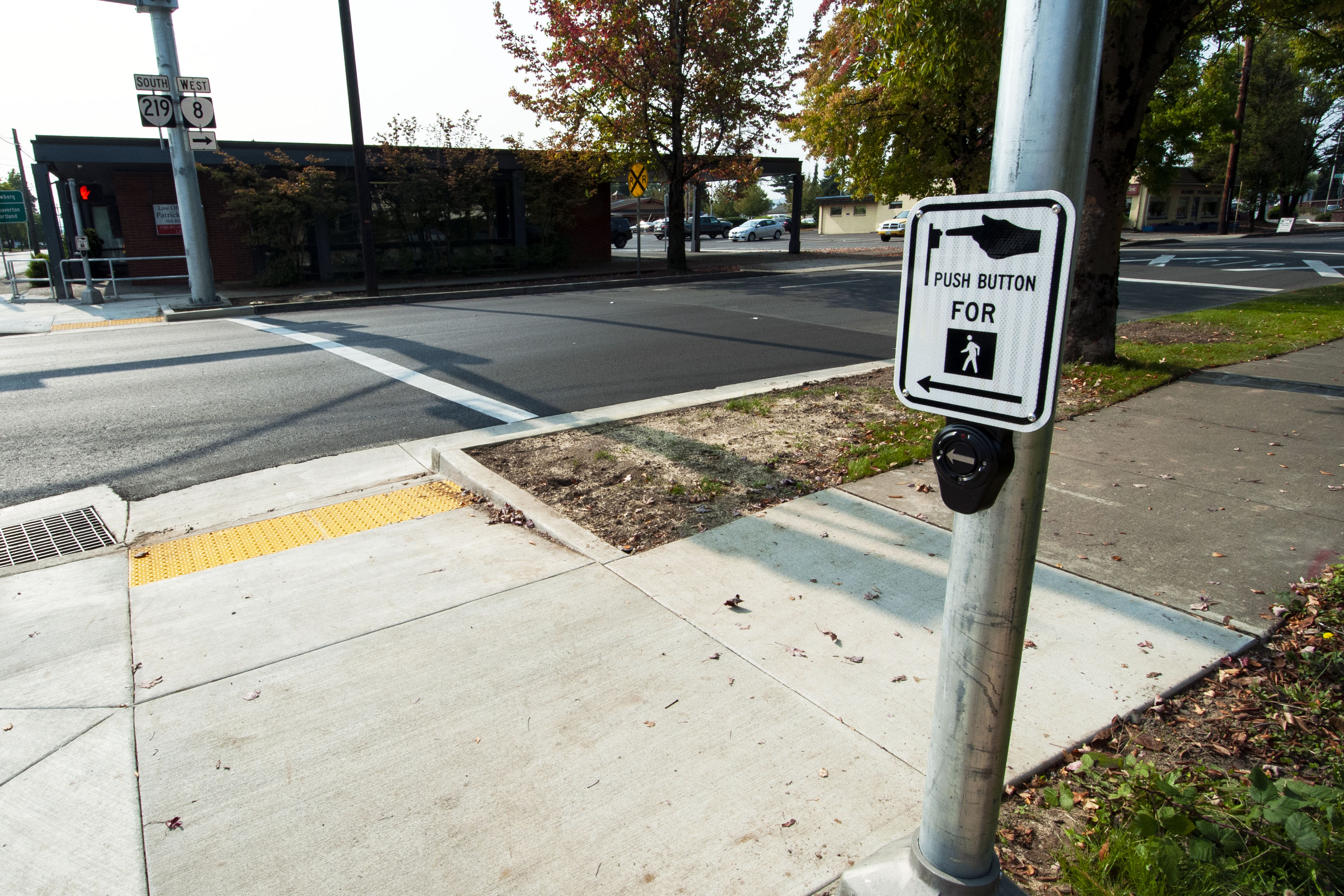 Example photo of a lowered crosswalk button at a crosswalk.