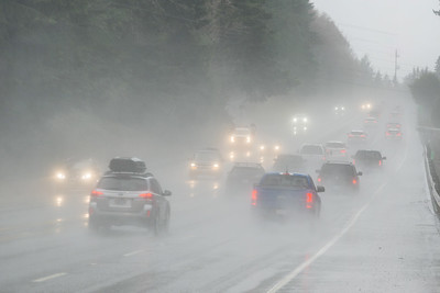 a photo of vehicles on the highway during a heavy rain storm