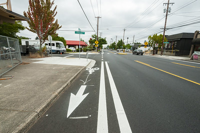 Photo of a local road intersection with a bike lane. 