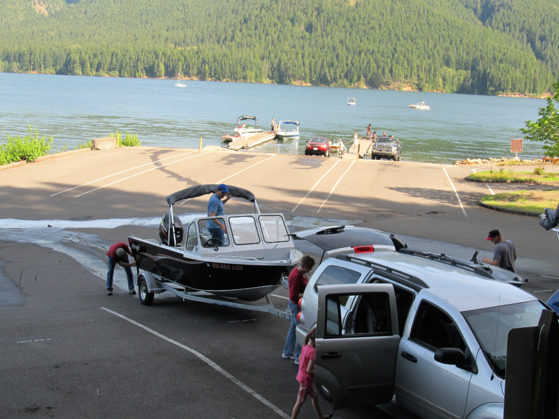 A family using the staging area to prep their boat before launching